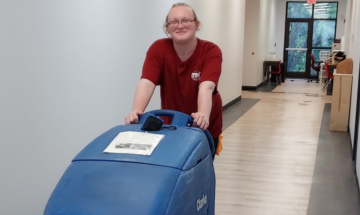 Man using a floor scrubbing machine